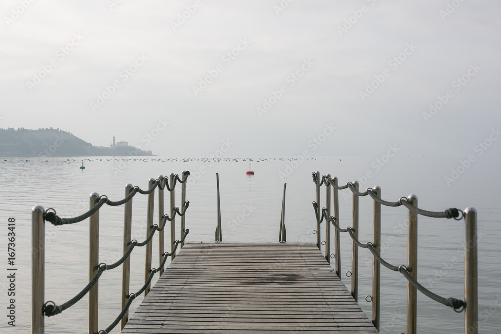 Pier in the sea with a grey sky