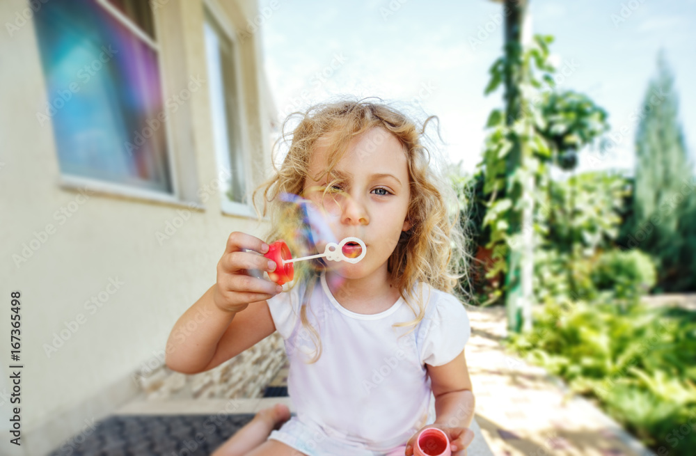 Cute little girl is blowing a soap bubbles. Cute little girl is blowing a soap bubbles.