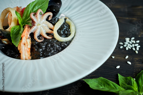 Dish of risotto with squid ink on grey plate jpg