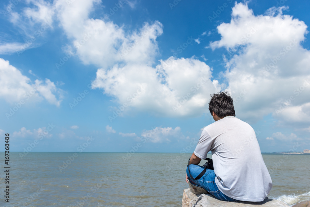 One man sitting alone, looking white cloud on the sky and thinking One man sitting alone, looking white cloud on the sky and thinking