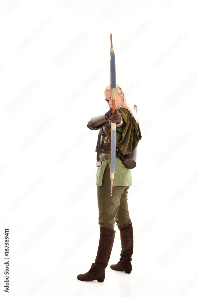 full length portrait of a blonde girl wearing green and brown medieval costume, holding a bow and arrow. isolated on white background. full length portrait of a blonde girl wearing green and brown medieval costume, holding a bow and arrow. isolated on white background.