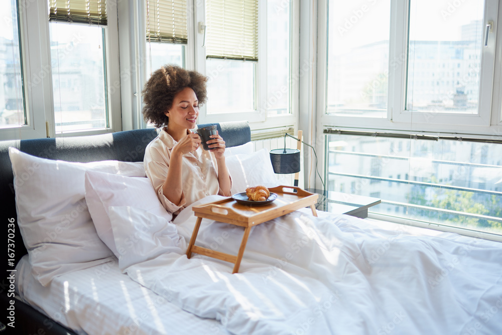 Beauty woman sitting on bed, eating breakfast Beauty woman sitting on bed, eating breakfast