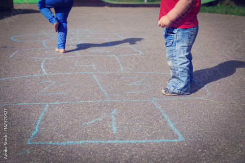 kids playing hopscotch on playground