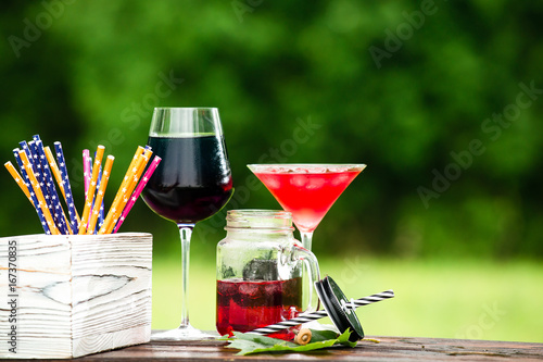 catering bar service. Selective focus on a cold cocktail in a mason jar, cocktail in martini glass and box with straws , copyspace. Concept of summer, vacation and relax
