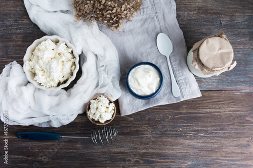 Top view of wooden table with dairy products - milk, yoghurt, sour cream - concept of healthy natural eating. Copy space.