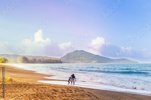  Asian family, dad, and son, enjoying their time at a beach in Phuket, Thailand