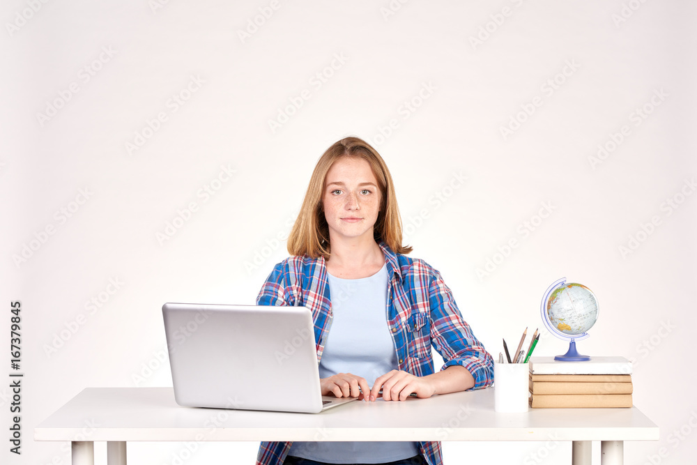 Portrait of teenage red-haired student sitting at desk Portrait of teenage red-haired student sitting at desk