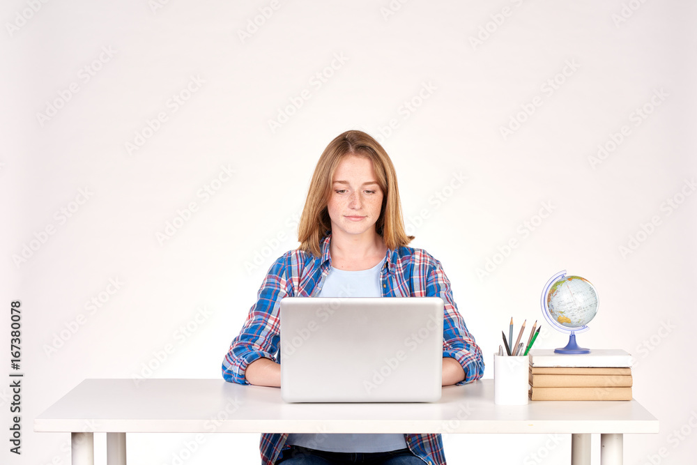 Portrait of teenage red-haired student sitting at desk Portrait of teenage red-haired student sitting at desk