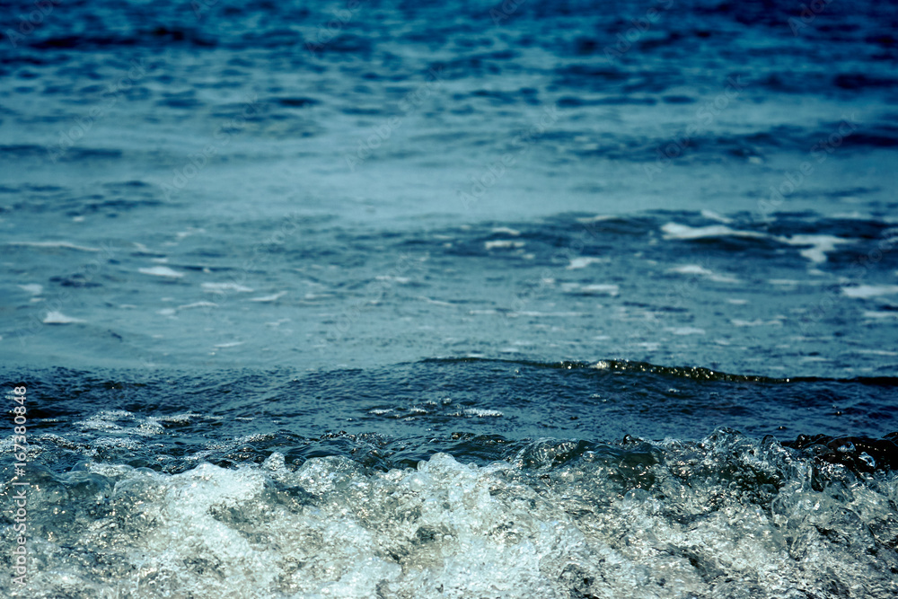 Fototapeta premium Background of the dark blue sea with bubble wave, Selective focus, vintage tone film effect