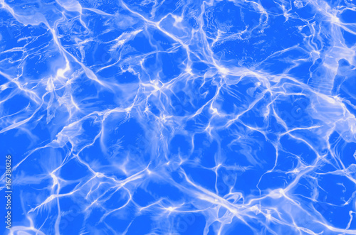 Solar flares on the blue water in the pool © Евгений Вдовин