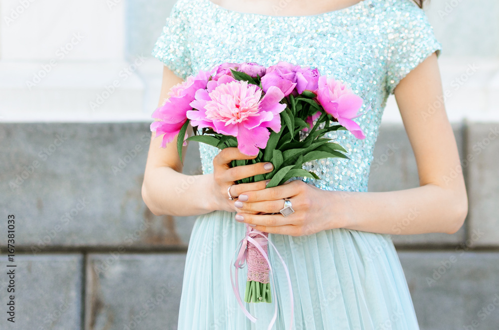 Pink bouquet in hands of the beautiful girl of the bride