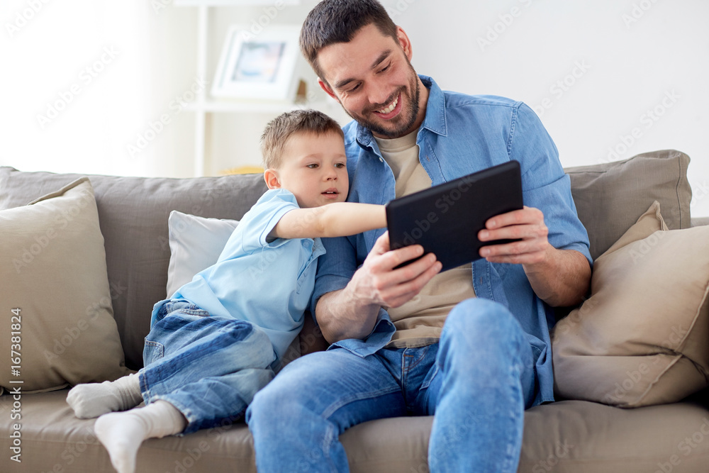 father and son with tablet pc playing at home father and son with tablet pc playing at home