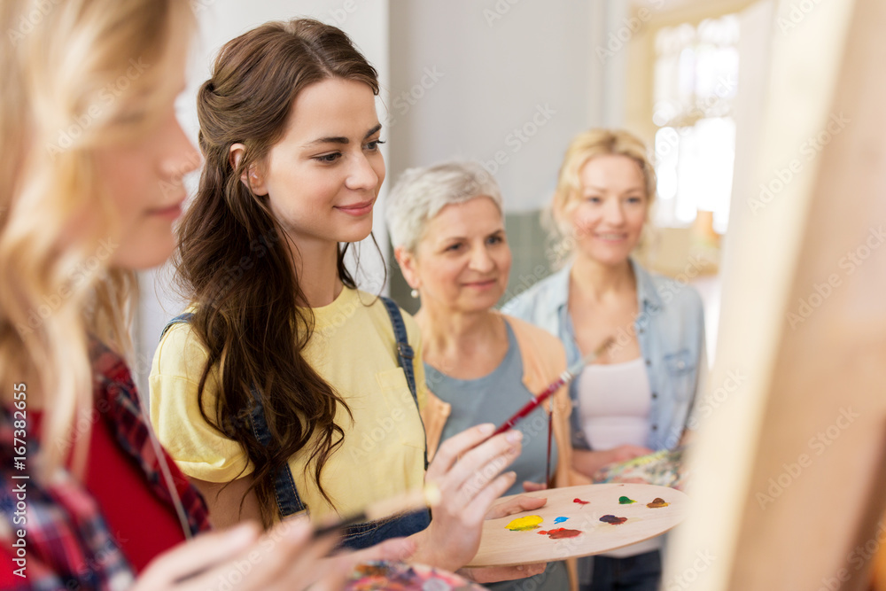women with easel and palettes at art school women with easel and palettes at art school