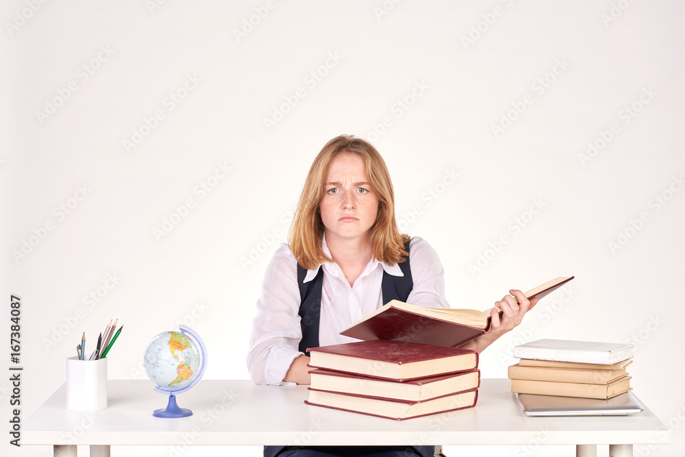 Portrait of red-haired female student studying at desk Portrait of red-haired female student studying at desk