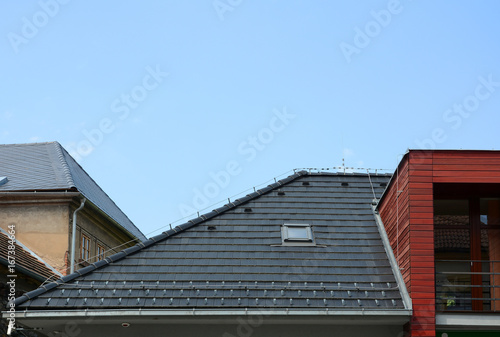 New Shingles Roof with Skylights Windows and Rain Gutter. New brick house with lightning conductor