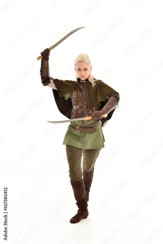 full length portrait of a blonde girl wearing green and brown medieval costume, holding a bow and arrow. isolated on white background. full length portrait of a blonde girl wearing green and brown medieval costume, holding a bow and arrow. isolated on white background.