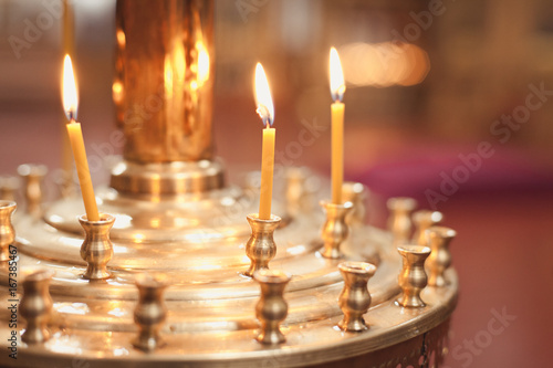 Candles and lamp close-up. Interior Of Orthodox Church In Easter. baby christening. Ceremony a in Christian . bathing the into the baptismal font