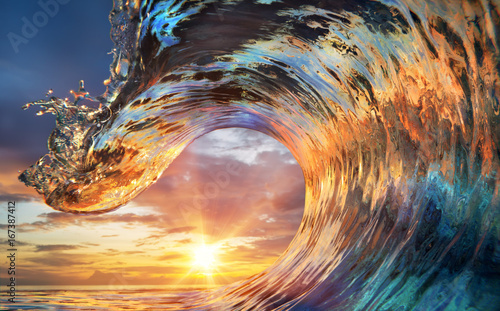 Colorful Ocean Wave. Sea water in crest shape. Sunset light and beautiful clouds on background © willyam