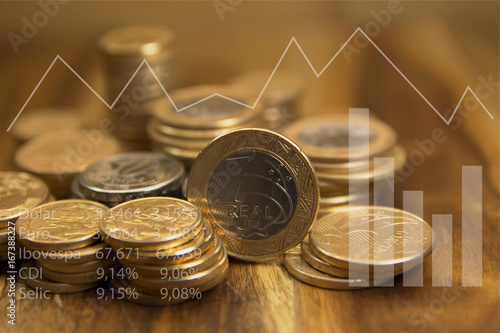 Brazilian coins and graphics. Economic indicators. Selective focus. photo