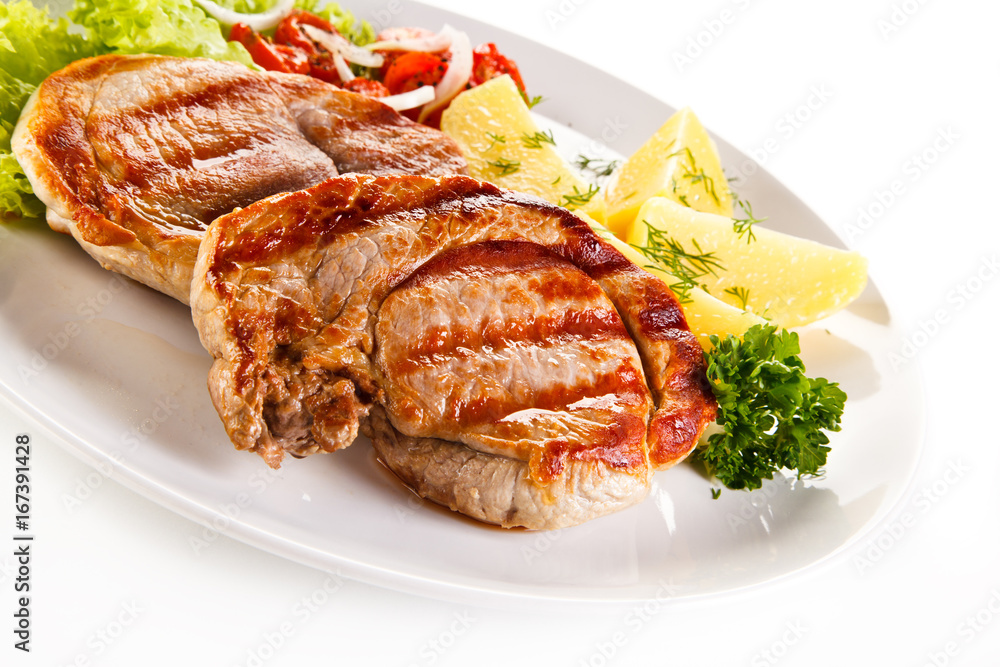Grilled steak, boiled potatoes and vegetable salad on white background