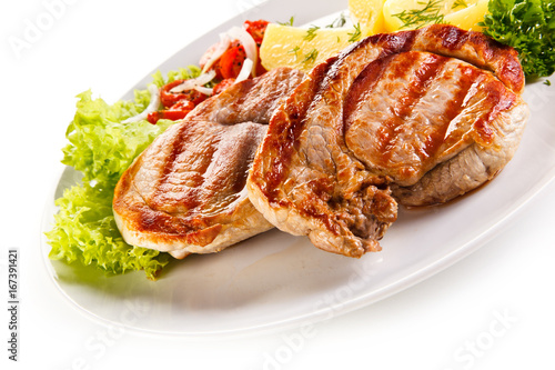 Grilled steak, boiled potatoes and vegetable salad on white background