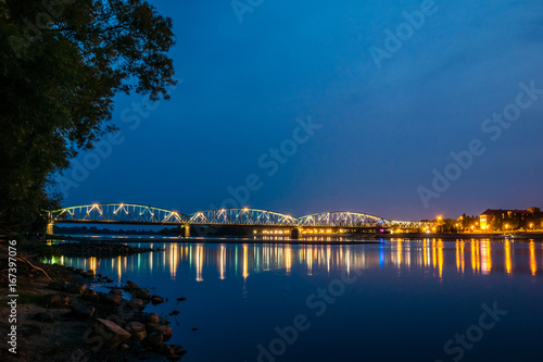 Night view of bridge over Vistula river in Torun, Poland