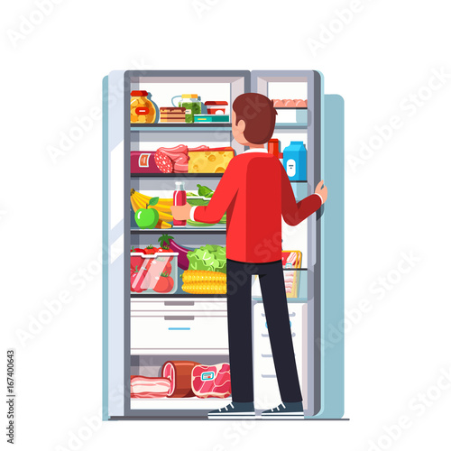 Man taking out juice from the open refrigerator
