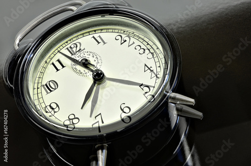 30 Minutes / close up of two, overlapping images with retro alarm clocks, showing different times, horizontal, slanted