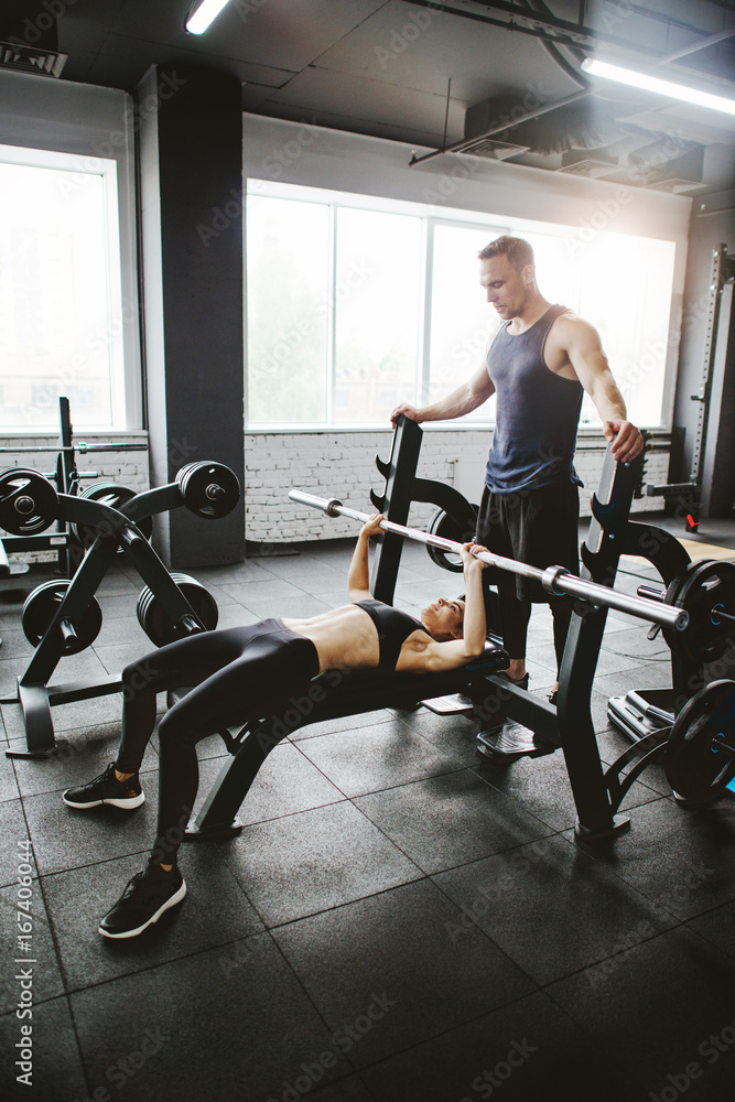 Young sporty couple workout in gym Young sporty couple workout in gym