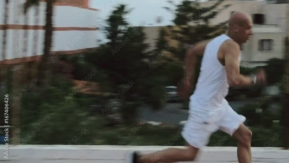 Man athlete running on treadmill outdoor. Man running in a circle. Man athlete running on treadmill outdoor. Man running in a circle.