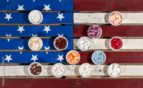Multiple containers of prescription drugs on USA flag