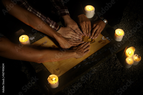 Summer night is good for communicating with ghosts through spiritual board photo