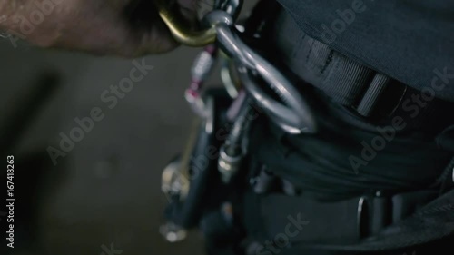 The steeplejack uncouples the hooks on the equipment on clothes