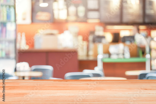 Blank Wood Table Top on Blurred coffee shop background or cafe restaurant background for montage product present.