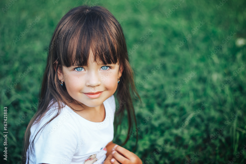 beautiful little girl looking at camera and smiling beautiful little girl looking at camera and smiling
