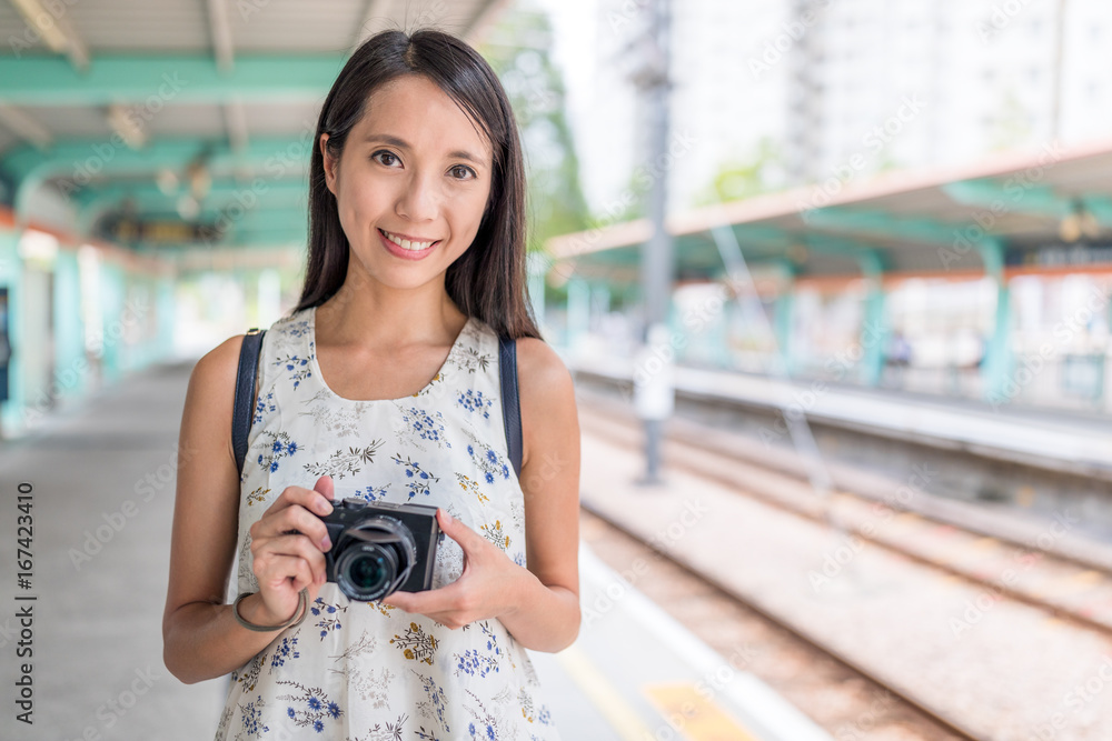 Woman holding camera in light rail station of Hong Kong Stock Photo ...