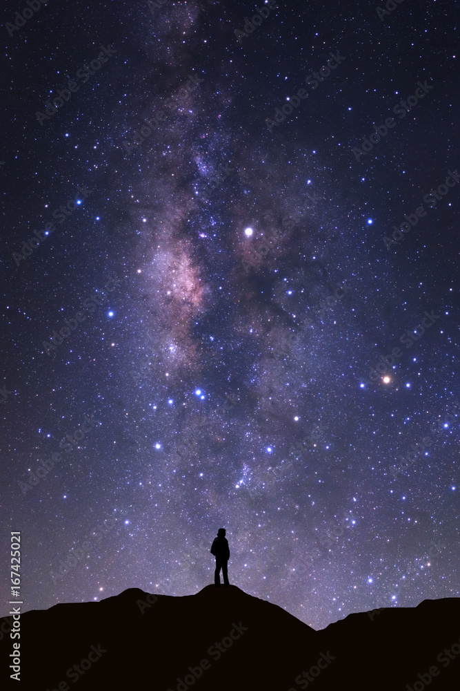 Fototapeta premium Landscape with milky way, Night sky with stars and silhouette of man standing on high moutain