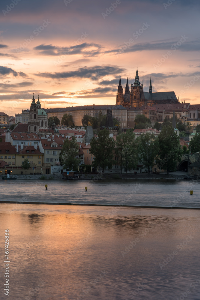 Vertical Prague Castle with cloudy sunset and Charles Bridge.