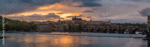 Panorama Prague Castle with cloudy sunset and Charles Bridge