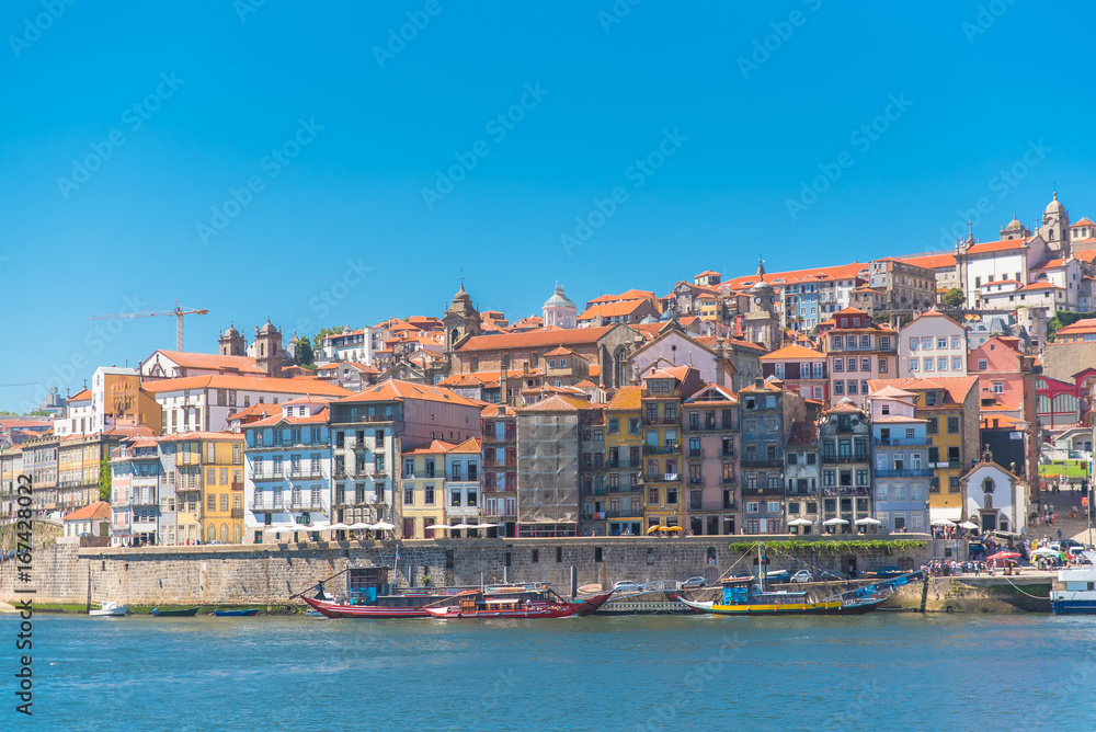     Porto in Portugal, the river Douro, colored buildings with tiles roofs and traditional boats

