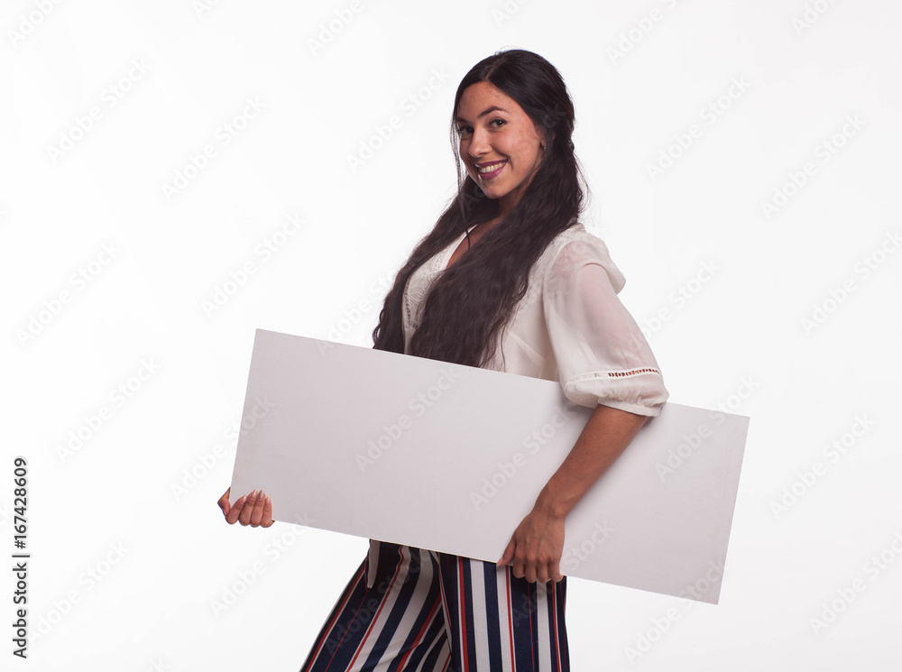 Young playful woman portrait of a confident businesswoman showing presentation, pointing placard gray background. Ideal for banners, registration forms, presentation, landings, presenting concept. Young playful woman portrait of a confident businesswoman showing presentation, pointing placard gray background. Ideal for banners, registration forms, presentation, landings, presenting concept.
