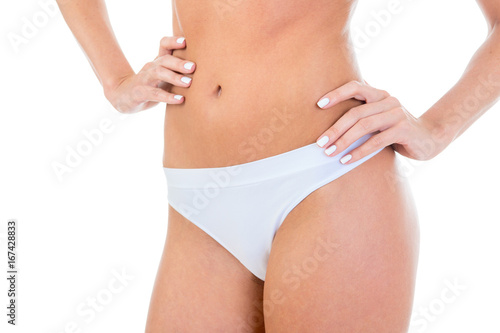 Slim female body in white underwear, on a white background