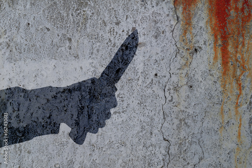 Shadow of human hand with killing knife on bloody wall background. Illustration for criminal chronicles.