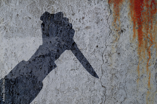 Silhouette of human hand with killing knife on bloody wall background. Illustration for criminal chronicles.