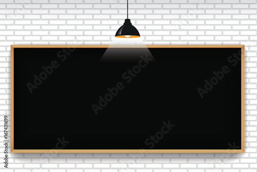 Blank blackboard in white brick wall background with hanging light