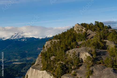 View point from cliff above valley with mountains and clouds. © Martin Hossa