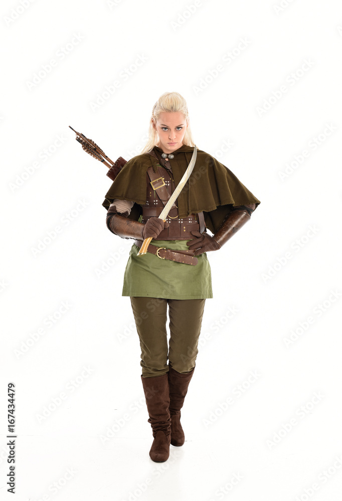 full length portrait of a blonde girl wearing green and brown medieval costume. standing pose isolated on white background.
