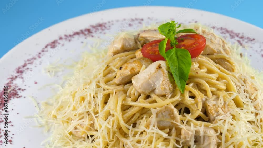 Chicken spaghetti with cheese and herbs, blue background ready for chroma key, loop, 4K, ProRes codec, 422 HQ, ISO 100 Chicken spaghetti with cheese and herbs, blue background ready for chroma key, loop, 4K, ProRes codec, 422 HQ, ISO 100