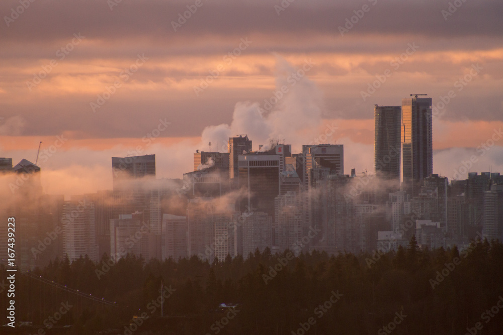 Plakat Colorful sunrise in city in clouds and fog