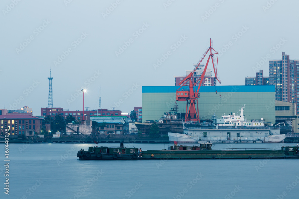 Ships on Huangpu River and cranes at the harbour,shanghai,china.